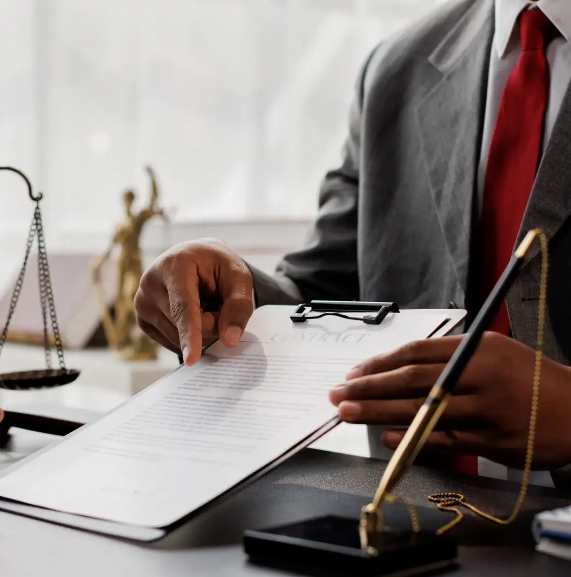 Lawyer reviewing document at office desk.